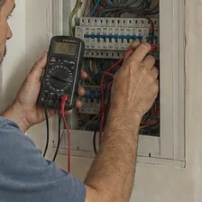 Technician checking an electrical panel at a client's home